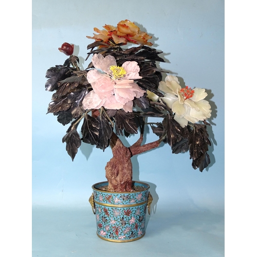 216 - A 20th century Oriental hardstone tree peony contained in a cloisonné-decorated circular pot, 57cm h... 