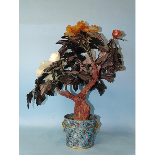 216 - A 20th century Oriental hardstone tree peony contained in a cloisonné-decorated circular pot, 57cm h... 