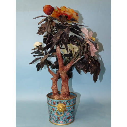 216 - A 20th century Oriental hardstone tree peony contained in a cloisonné-decorated circular pot, 57cm h... 