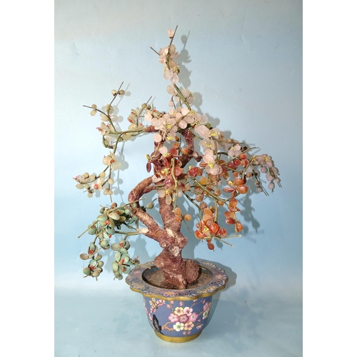 217 - A 20th century Oriental hardstone tree with blossom and fruits, contained in a cloisonné-decorated p... 