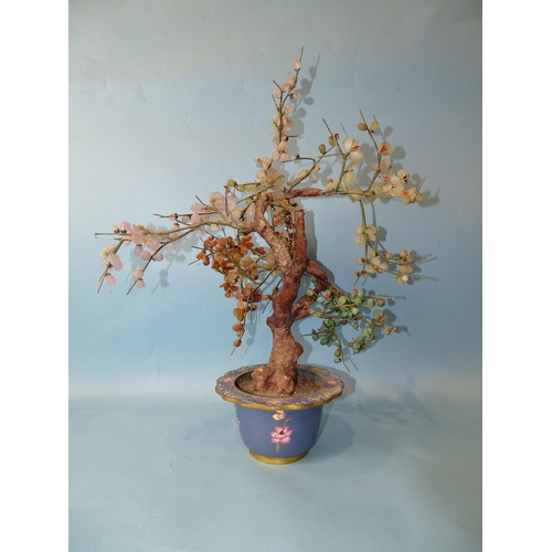 217 - A 20th century Oriental hardstone tree with blossom and fruits, contained in a cloisonné-decorated p... 