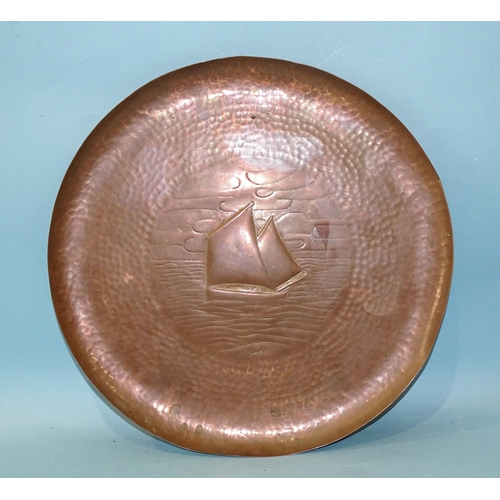 219 - A Newlyn copper circular tray with embossed lugger decoration, impressed mark NEWLYN, 33.5cm diamete... 