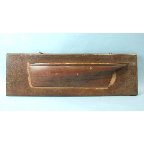 222 - An early-20th century laminated half-block model of a boat hull, (comb and rudder lacking), 48cm lon... 