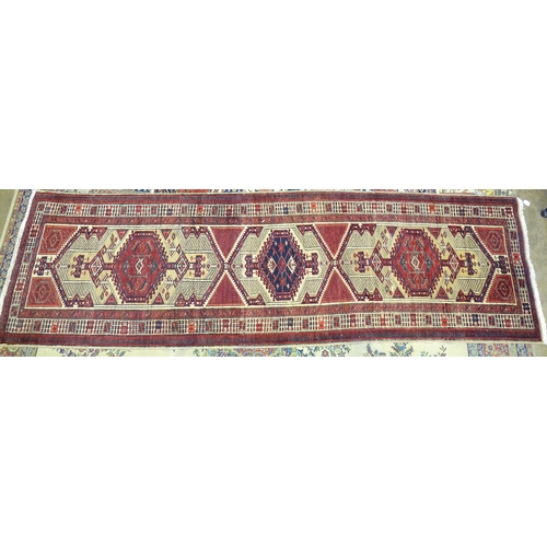 226 - A modern Oriental corridor runner with central serrated lozenges on a camel ground, 350cm long, 103c... 