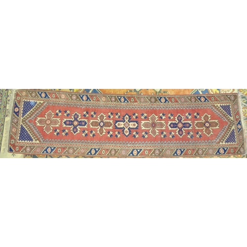 228 - A late-20th century Turkish carpet, the pillared symmetric centre within a wide triple border, 204 x... 