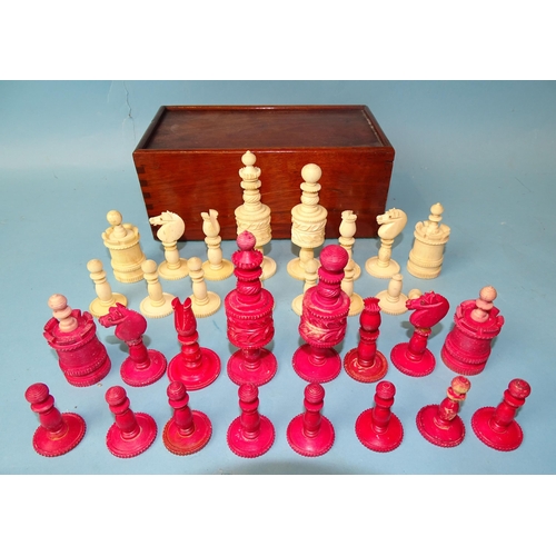 229 - A late-19th century carved  and stained bone chess set, one white pawn missing, small damages, in ma... 