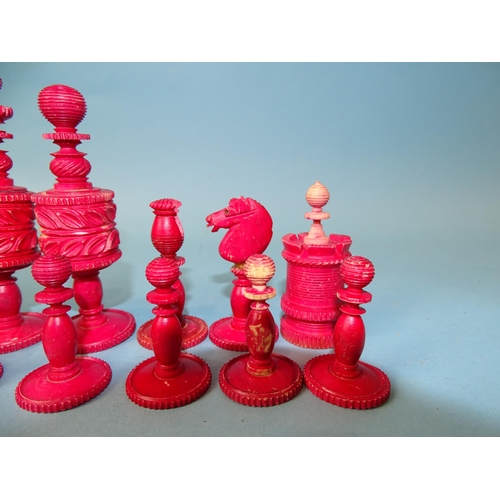 229 - A late-19th century carved  and stained bone chess set, one white pawn missing, small damages, in ma... 