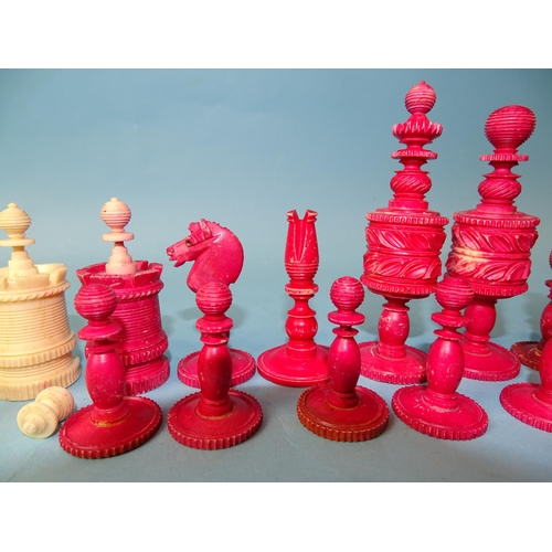 229 - A late-19th century carved  and stained bone chess set, one white pawn missing, small damages, in ma... 