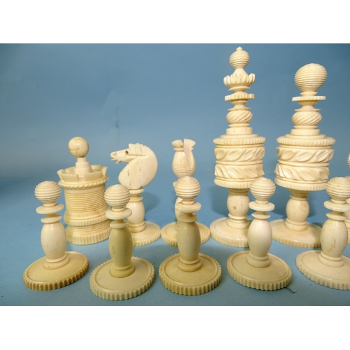 229 - A late-19th century carved  and stained bone chess set, one white pawn missing, small damages, in ma... 