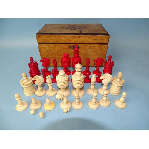 229 - A late-19th century carved  and stained bone chess set, one white pawn missing, small damages, in ma... 