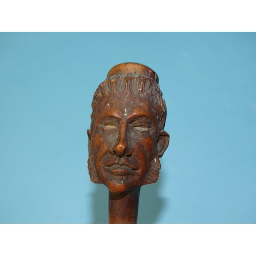 238 - A late-19th/early-20th century carved wood pipe in the form of a whiskered male figure, 16cm long, f... 