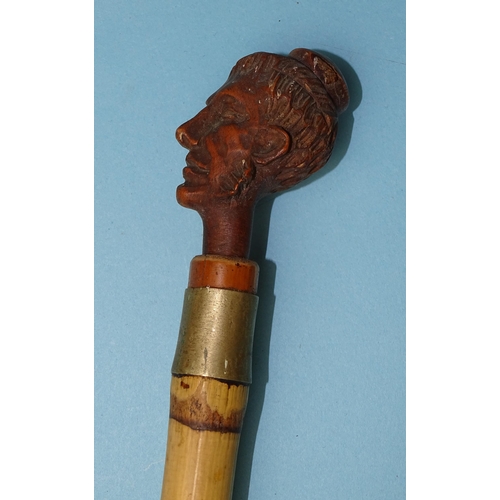 238 - A late-19th/early-20th century carved wood pipe in the form of a whiskered male figure, 16cm long, f... 