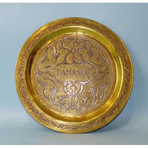 246 - A Damascus 'Cairo ware' circular brass plate with white metal and copper inlaid decoration, 29cm dia... 