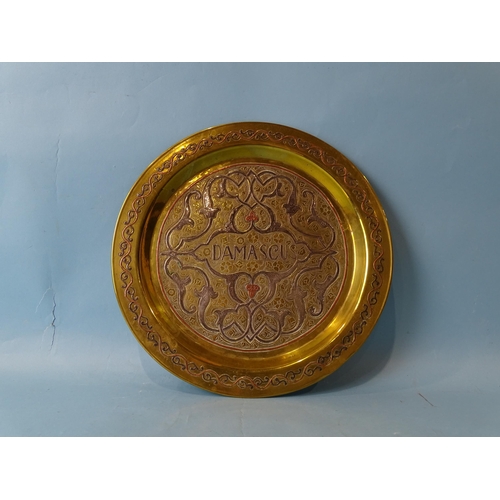 246 - A Damascus 'Cairo ware' circular brass plate with white metal and copper inlaid decoration, 29cm dia... 