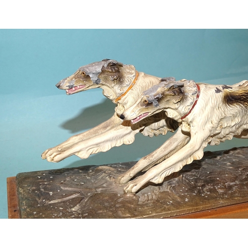 247 - An Austrian painted spelter table-top match strike in the form of two wolfhounds running, the match ... 