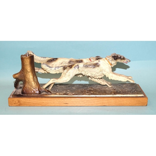 247 - An Austrian painted spelter table-top match strike in the form of two wolfhounds running, the match ... 