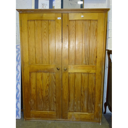 24 - A pitch pine two-door storage cupboard, 110cm wide, 148cm high, a small stripped pine wash stand, 80... 