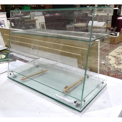 37 - A shop counter top three-tier glass display shelves, 60.5cm wide, 45.5cm high, 30.5cm deep at base.... 
