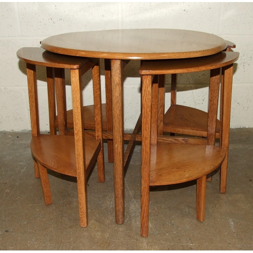 7 - An oak circular nest of five tables, 60cm diameter and two stools, (3).