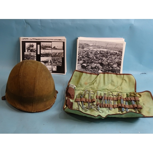 705 - A Falklands War Argentinian steel helmet with camouflage cover and inner shell with webbing, 27 x 19... 