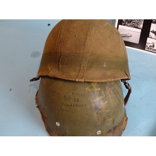 705 - A Falklands War Argentinian steel helmet with camouflage cover and inner shell with webbing, 27 x 19... 