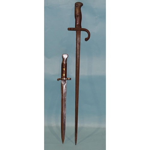 706 - A Belgian 1876 pattern sword bayonet with bronze and iron fittings and wood grips, the single-edge 5... 