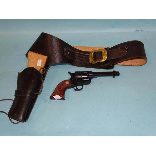 710 - A replica Phoenix Arms America Western revolver, in leather holster and belt.