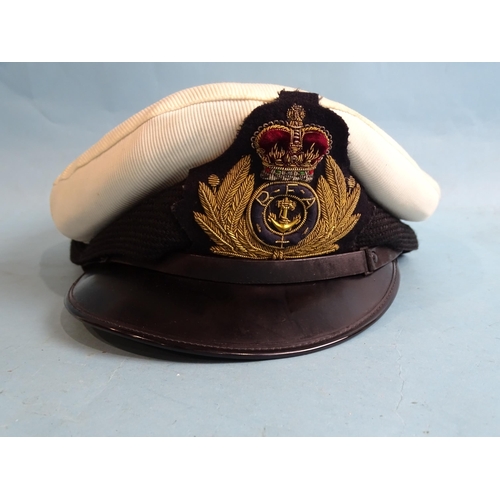 718 - A Royal Fleet Auxiliary Merchant Navy uniform jacket, hat, three pairs of epaulettes, buttons, etc.... 