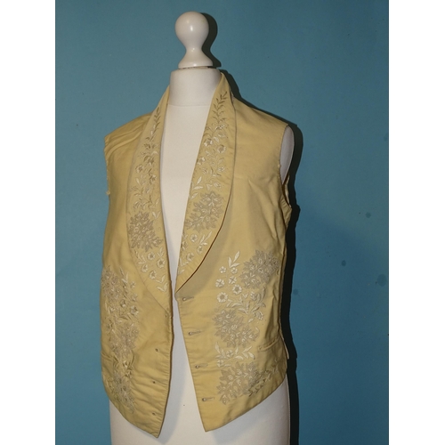 748 - A Victorian gentleman's ivory silk waistcoat, the revers and front embroidered in cream silk with fl... 