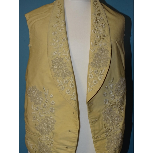 748 - A Victorian gentleman's ivory silk waistcoat, the revers and front embroidered in cream silk with fl... 