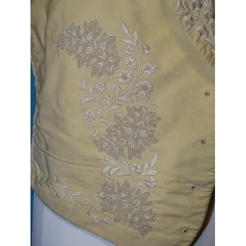 748 - A Victorian gentleman's ivory silk waistcoat, the revers and front embroidered in cream silk with fl... 