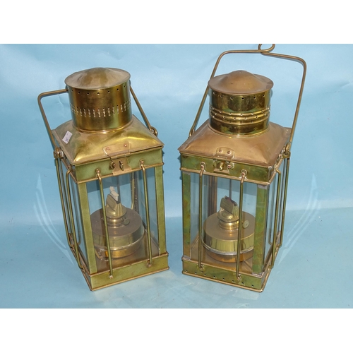 773 - Two vintage brass 20th century oil lamps with hinged tops, four glazed side panels and carrying hand... 