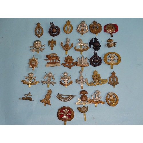 790 - A collection of thirty-two various military badges.