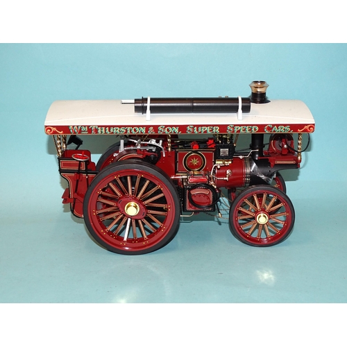 671 - Two Chinese-made models of fairground traction engines, a tinplate battery-driven American-style loc... 