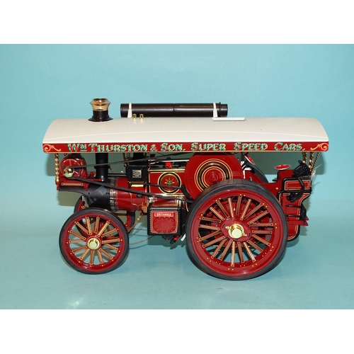 671 - Two Chinese-made models of fairground traction engines, a tinplate battery-driven American-style loc... 