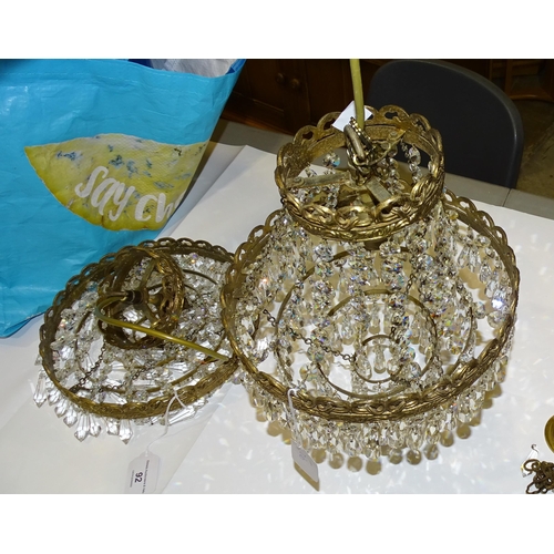 92 - A pair of four-stage gilt metal hanging light fittings with cut-glass drops, complete with ceiling r... 