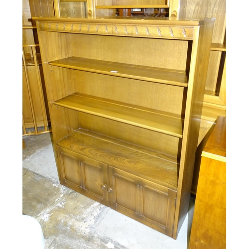 1 - An Ercol 'Golden Dawn' elm bureau fitted with a fall front above two drawers and two cupboard doors,... 