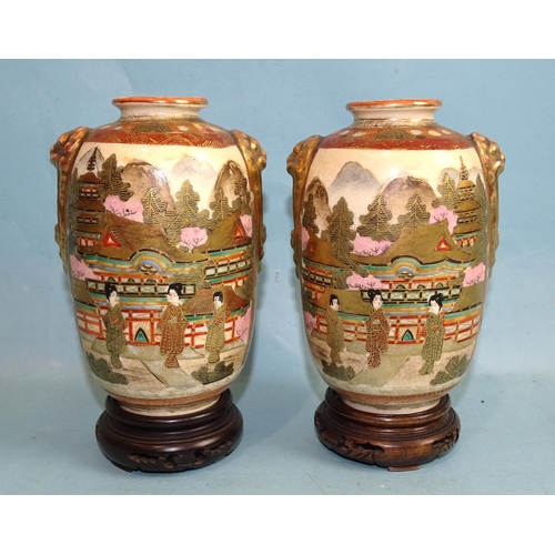 128 - A pair of small baluster Satsuma decorated Japanese vases, with lion mask handles and figures in a l... 