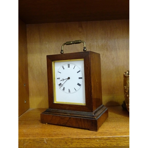 121 - An early-19th century rosewood small mantel clock of rectangular shape, with white enamel dial and b... 