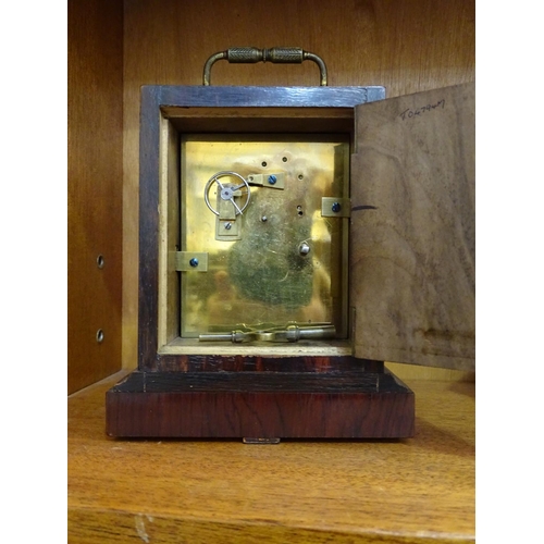 121 - An early-19th century rosewood small mantel clock of rectangular shape, with white enamel dial and b... 