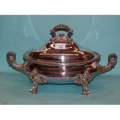 132 - A plated two-handled tureen and cover of oval form on four applied supports, 45cm long, 26cm high.... 