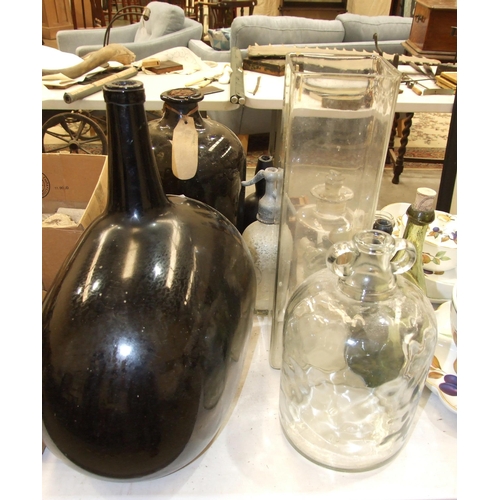 104 - A large amber glass shaped carboy, a liquid paraffin pharmaceutical bottle with pourer, other glass ... 