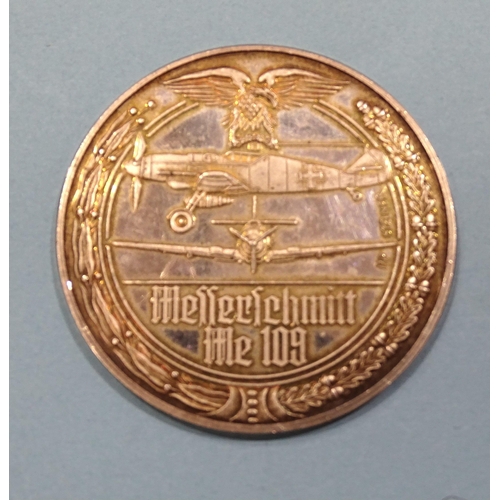 138 - A 1970's silver medallion commemorating the Messerschmitt Me-109 German fighter plane, designed by P... 