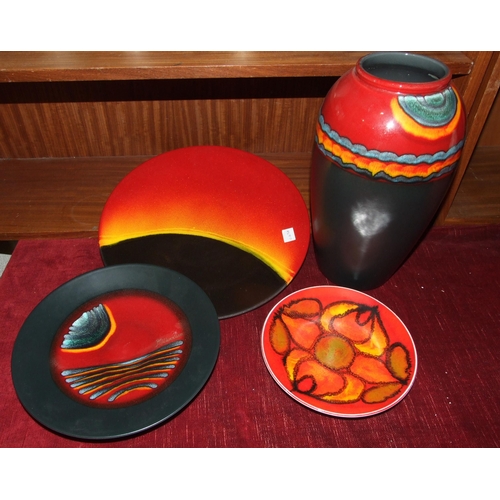 84 - A Poole Pottery 'Eclipse' decorated charger, 35cm, a Poole Pottery 'Millennium' charger, 26.5cm, a '... 