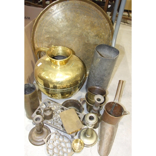 94 - A large brass jug, 34cm high, a brass Benares tray, 59cm diameter, a copper slipper warmer and other... 