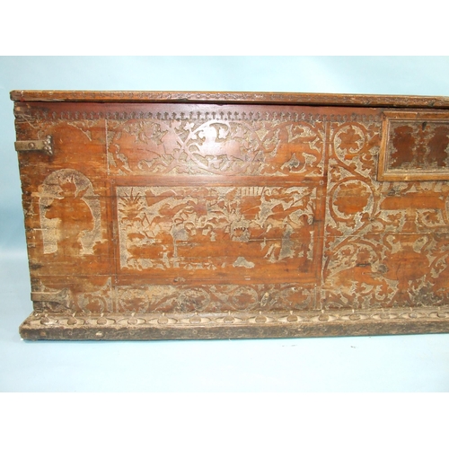 33 - A 17th/18th century Italian cedar wood cassone, carved overall with figures and animals in shallow r... 