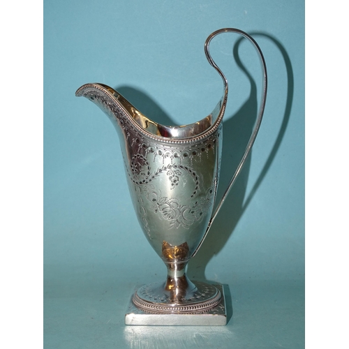 333 - A George III silver cream jug of helmet shape with reeded handle, on pedestal foot with square base,... 