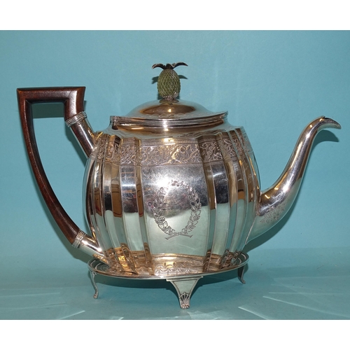 336 - A George III silver teapot on stand, of oval fluted form with engraved decoration and pineapple fini... 