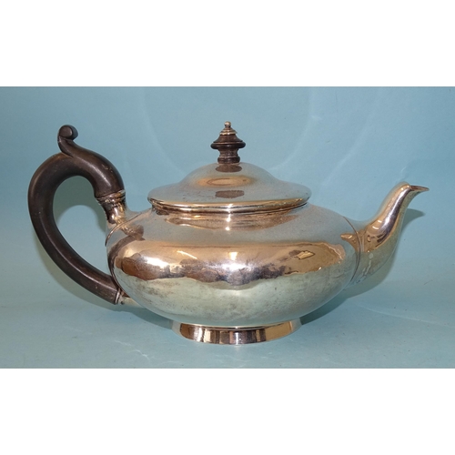 350 - A George IV silver teapot of squat baluster form, with carved wood handle, on circular foot, maker R... 