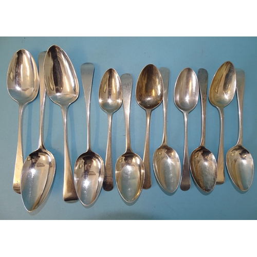 353 - A collection of Georgian Old English pattern silver dessert spoons: three tablespoons and nine desse... 